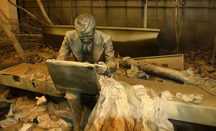 Sculpture of dazed businessman on bench