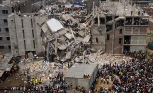 Aerial view of Hundreds of rescue workers surrounding collapsed concrete building on Rana Plaza