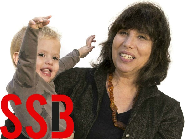 Alison Gopnik shown holding a grandchild whose arms are outstretched