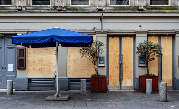 Boarded-up restaurant seen from street