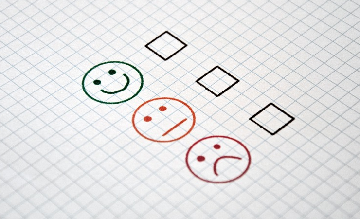Image: three check boxes next to a smiley face, a neutral face, and a frowny face.