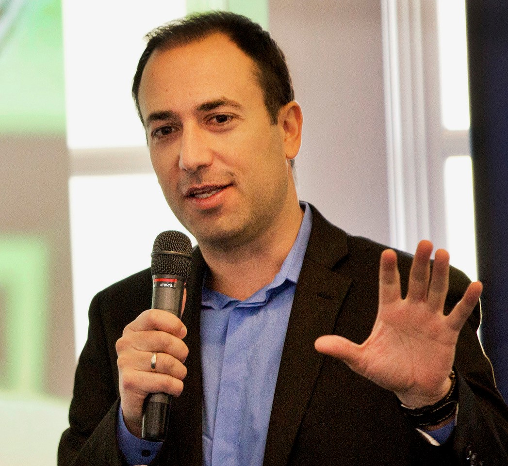 Candid photo of Dimitris Xygalatas with a microphone in his hand