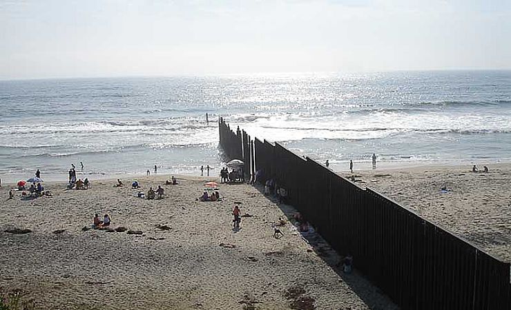 Fence bisects border beach