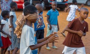 Children in Ghana playing game with one wearing a blindfold