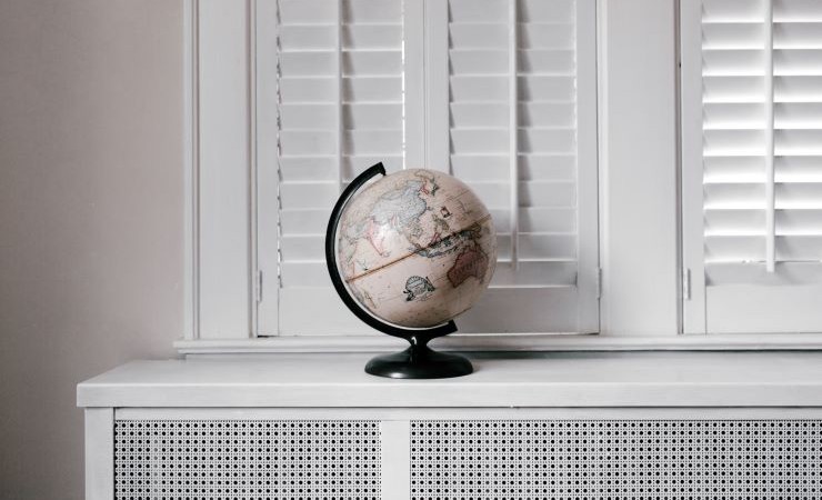 Photo: Globe sits on shelf under window.