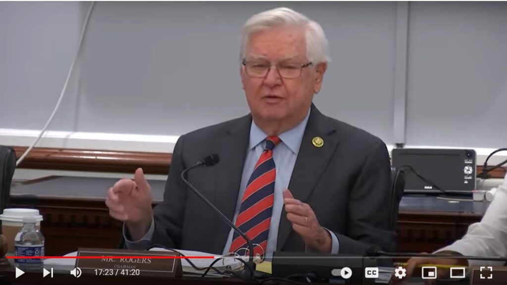 A seated Hal Rogers, his hands spread apart, speaks during hearing