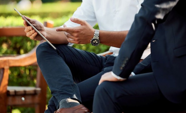 Two businessmen having a meeting in a park.