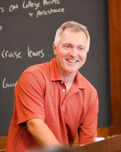 John ist at classroom podium