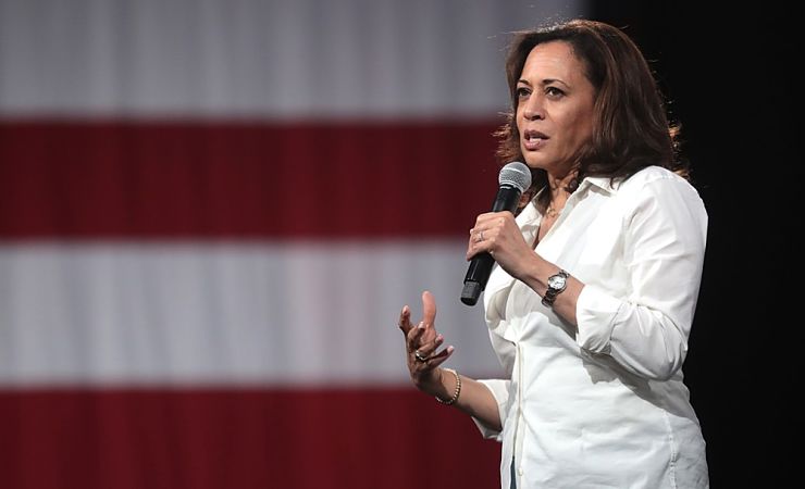 Kamala Harris speaking in front of US flag