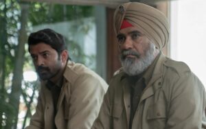 A still from the series Kohrra shows actors Suvinder Vicky and Barun Sobti in police khakis and with pensive looks