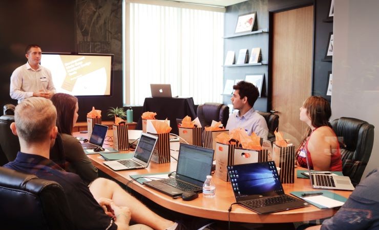 Image: manager presenting in conference room.