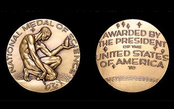 Two sides of a gold medal showing a naked man's figure with head bowed and hand outstretched offering item