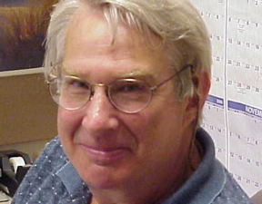 Headshot of Norman Denzin in his office