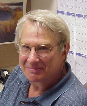 Headshot of Norman Denzin in his office