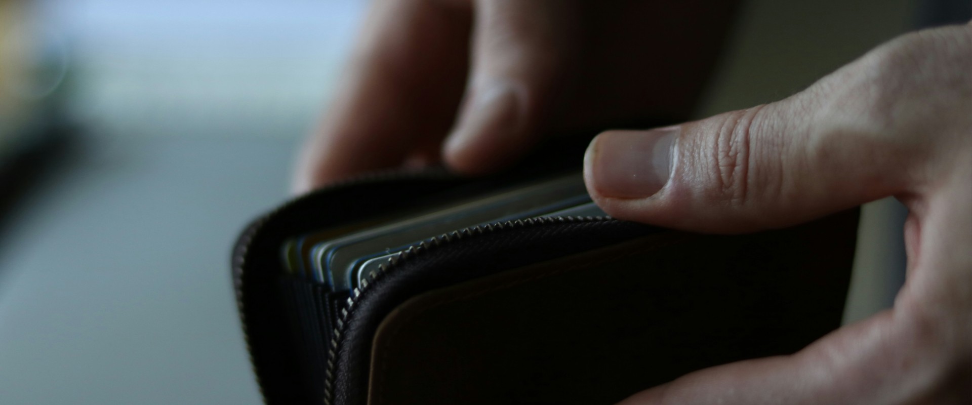 Closeup of hands opening wallet