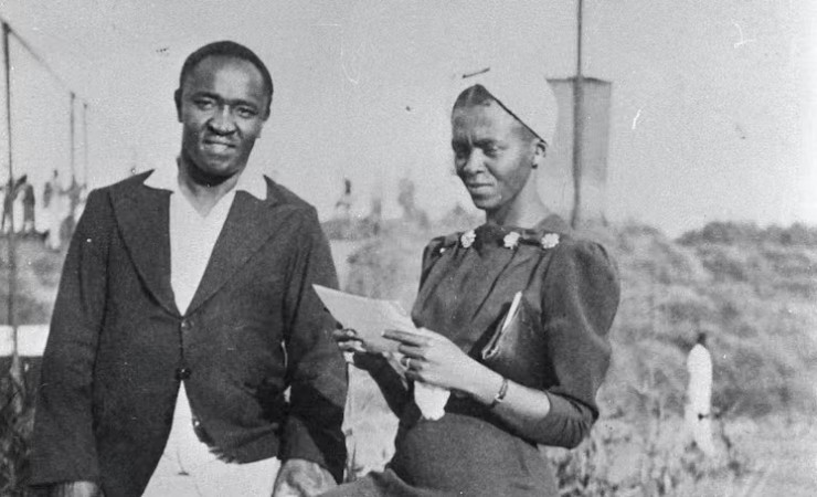 Couple in professional clothing standing outside in black and white photo from the 1930s