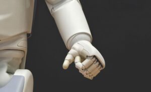 Close-up image of torso and arm of white humanoid robot.