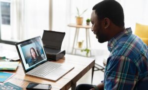 A remote worker videochats on his laptop.