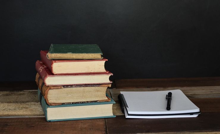 Stack of books and a notepad