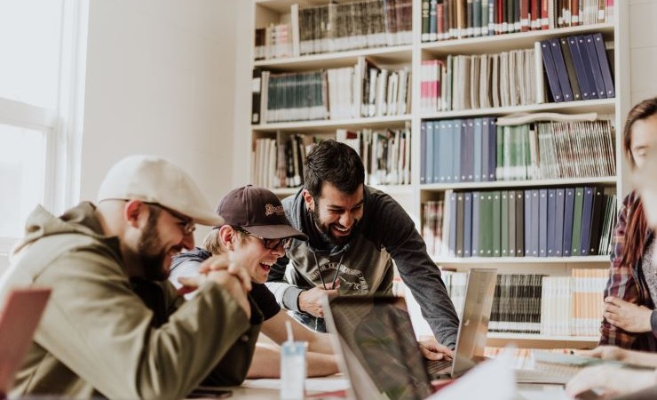 Image: students collaborating in a library.