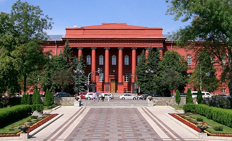 landscape view of the pillared entrance to the brick-red building