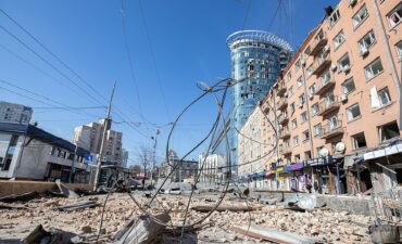 An urban street covered in rubble and loose wires