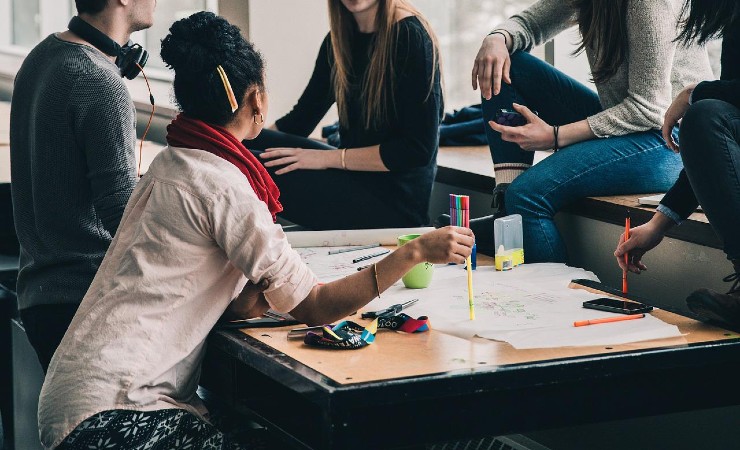 Woman seated at table at casual business meeting