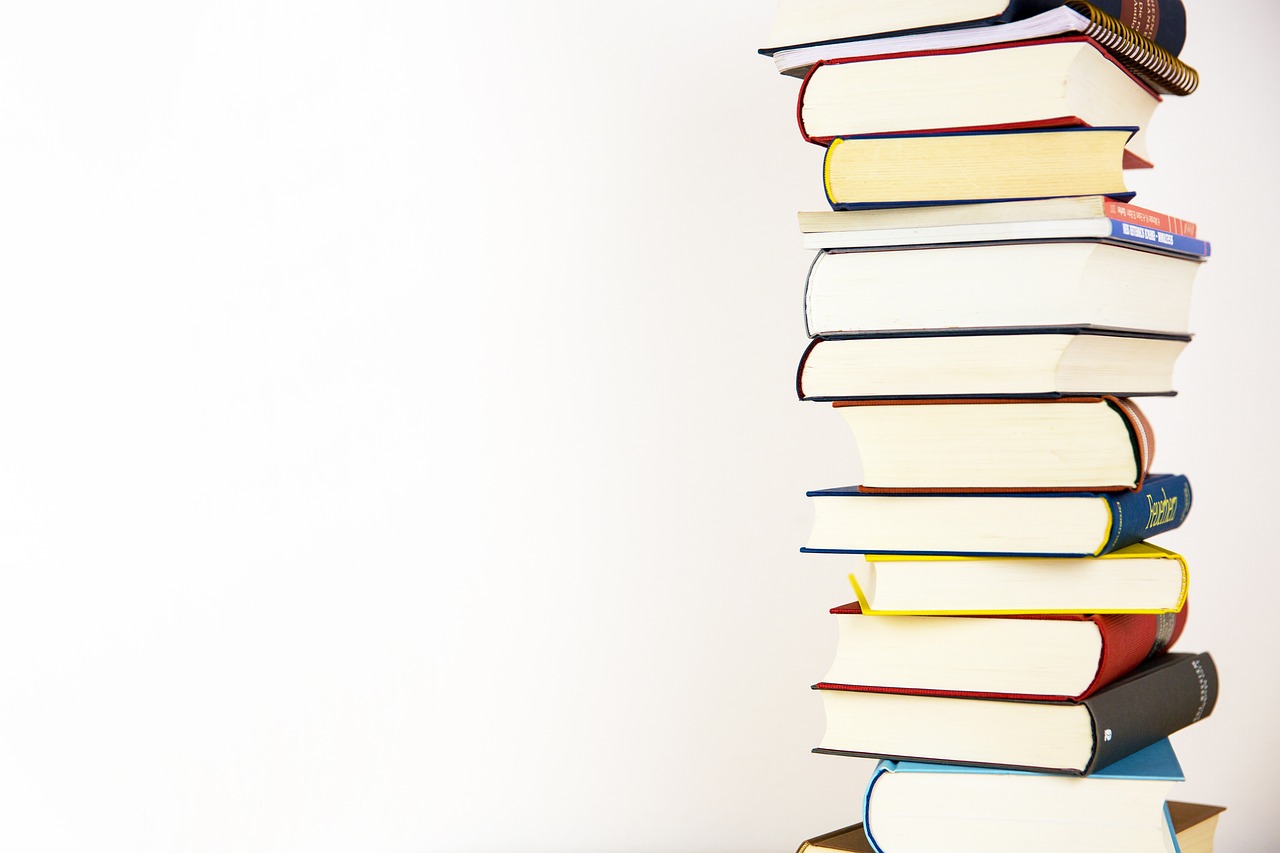 A stack of books against a plain background.