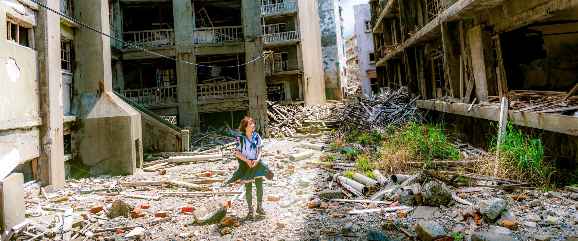 Child wanders though zone of destroyed buildings in war zone