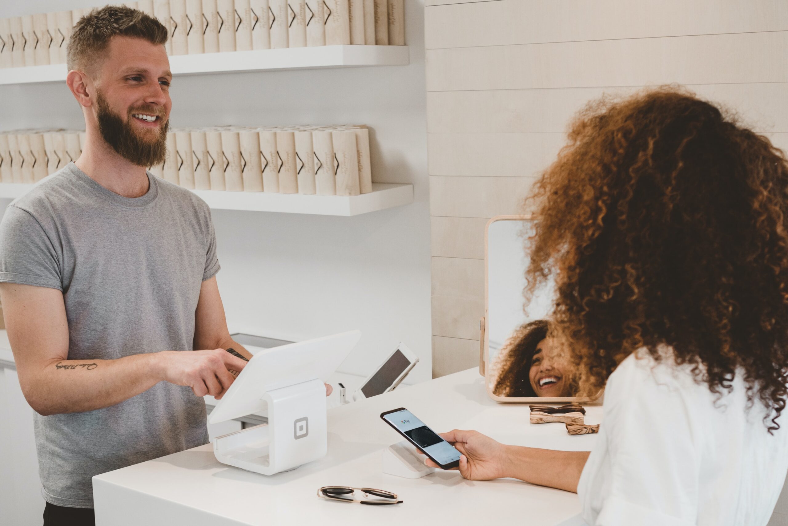 Customer and employee are pictured joyfully interacting.