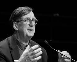 Bruno Latour speaking into a microphone