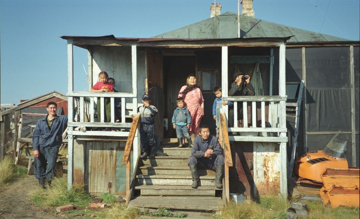 several generations of family on steps of wood-frame house