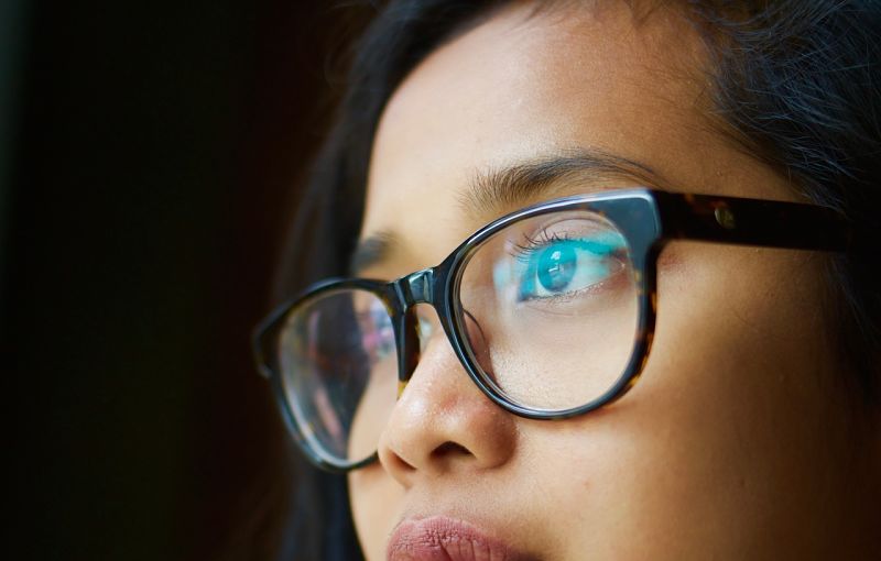 Woman in glasses looking at screen
