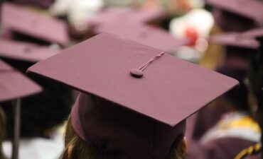 Maroon graduation caps shown from the top.