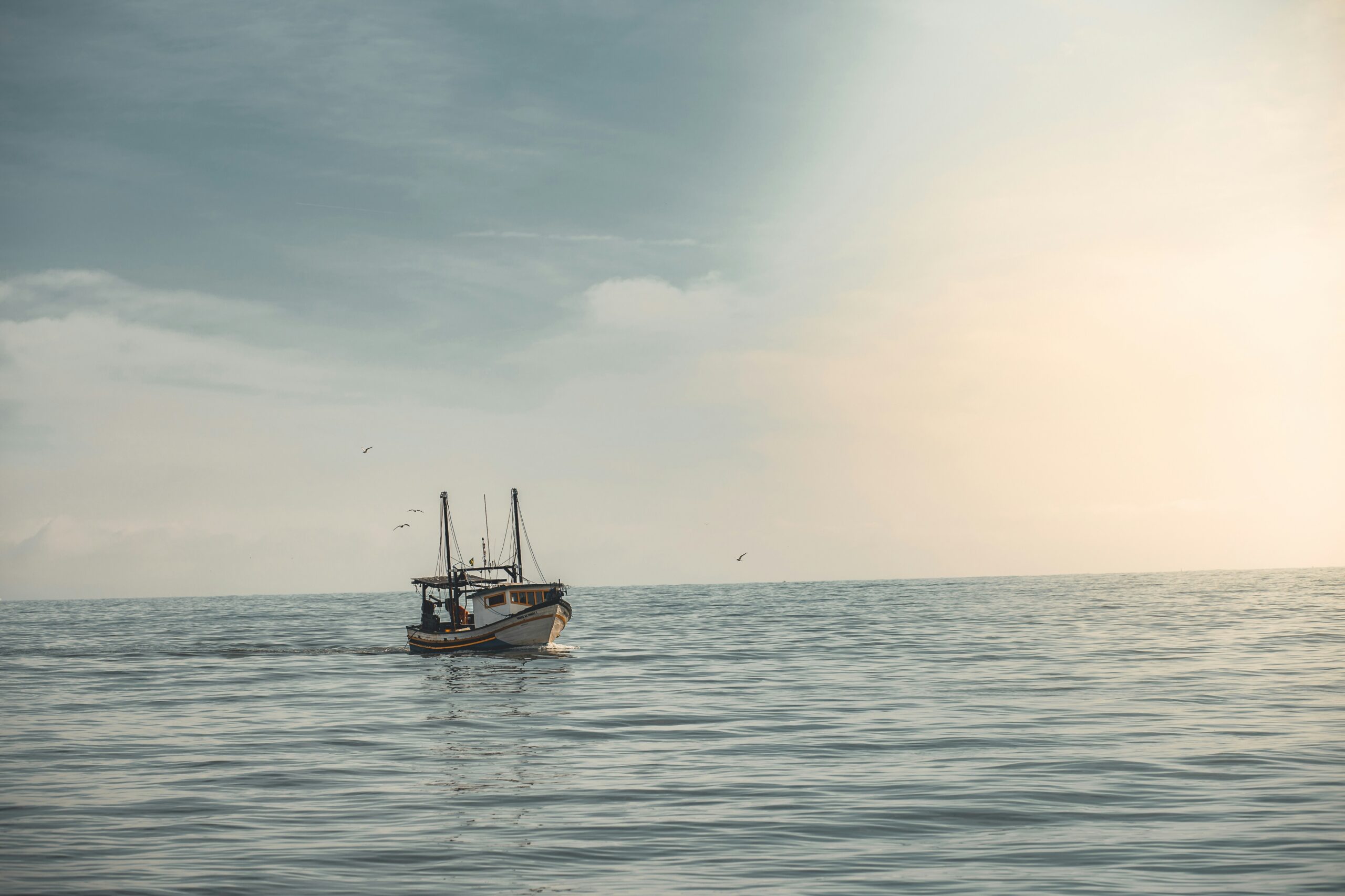 Solitary boat pictured in open ocean.