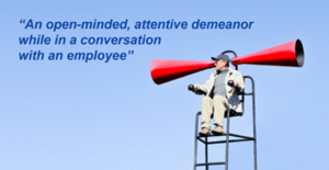Man in chair yelling into two megaphone with text ovrlay of 'an open minded attentive demeanor while in conversation with an employee'