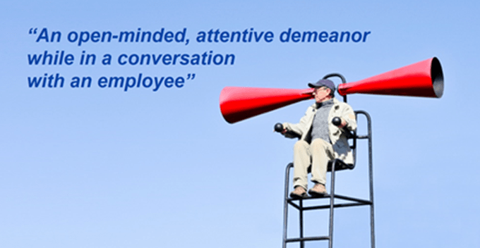 Man in chair yelling into two megaphone with text ovrlay of 'an open minded attentive demeanor while in conversation with an employee'