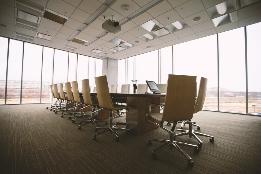 Picture of empty chairs around table in company boardroom