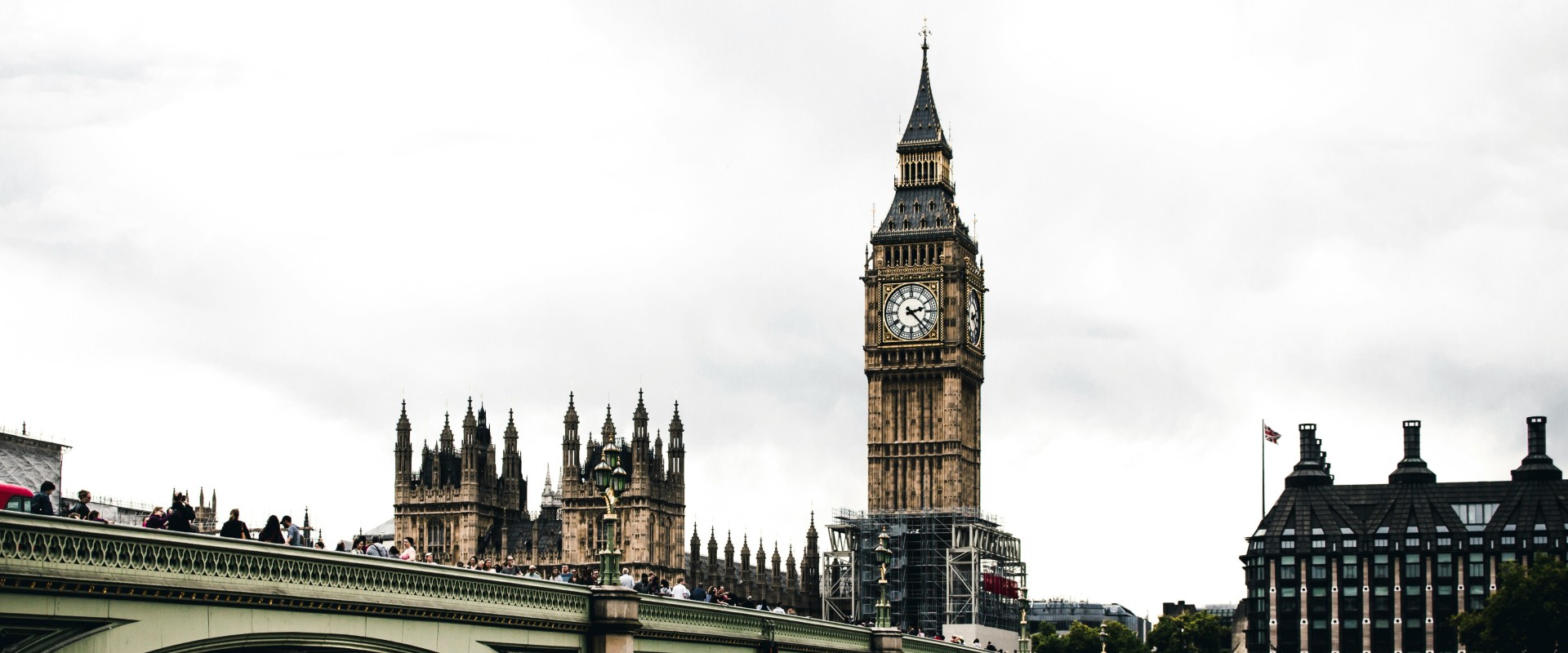 Moody scenic of Big Ben and UK parliament building just beyond bridge over Thames