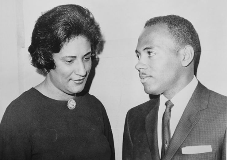 Black and white news photo shows Constance Baker Motley listening to hre client
