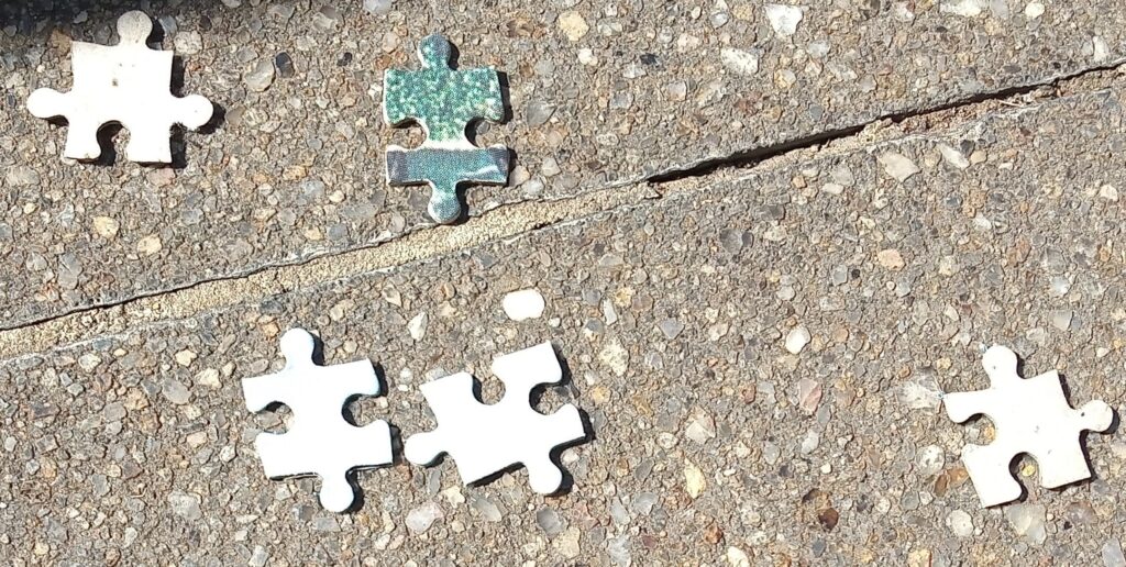 Jigsaw pieces on cement