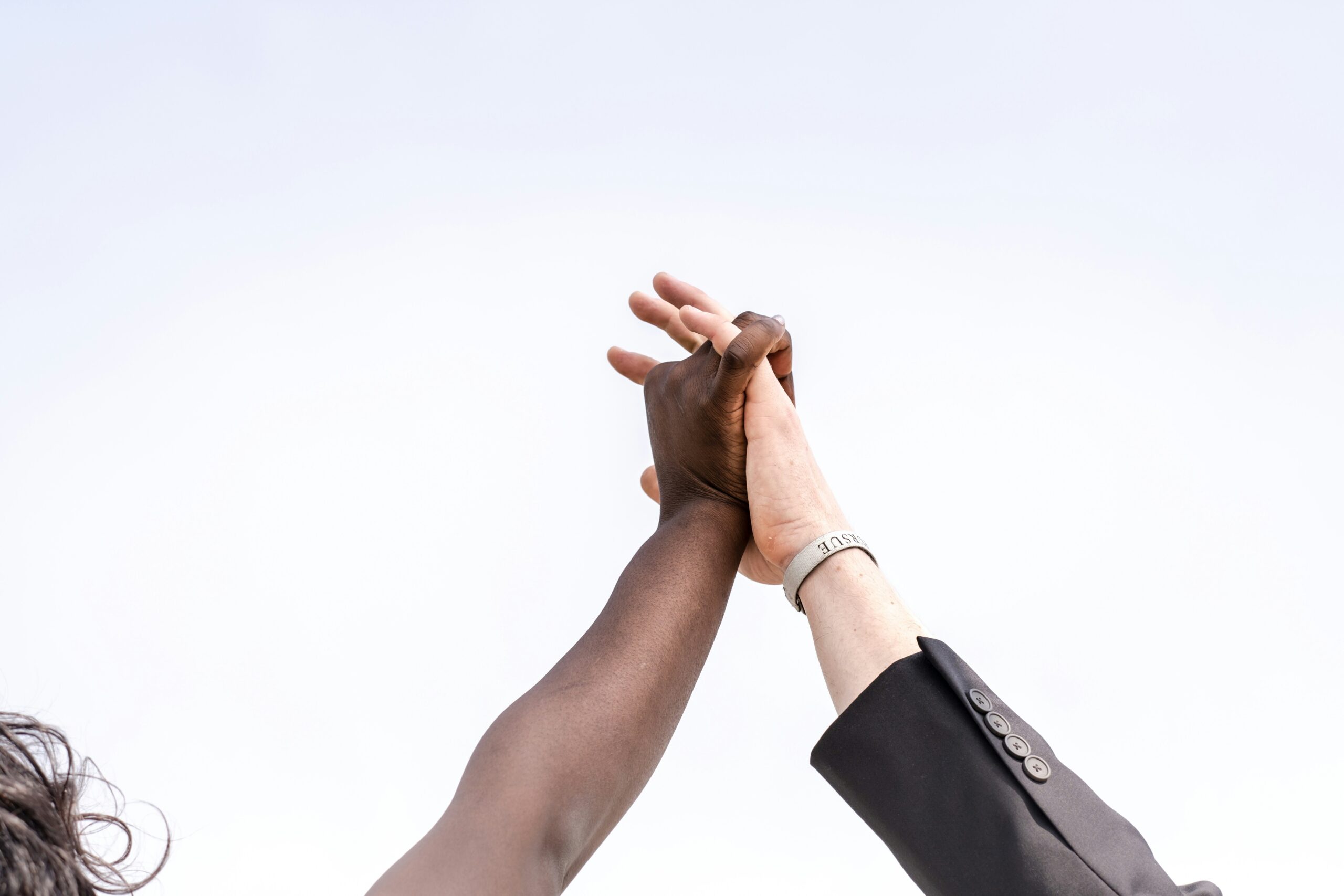 Close up of two hands clasped in a high five