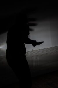 Scary silhouette of knife-wielding attacker