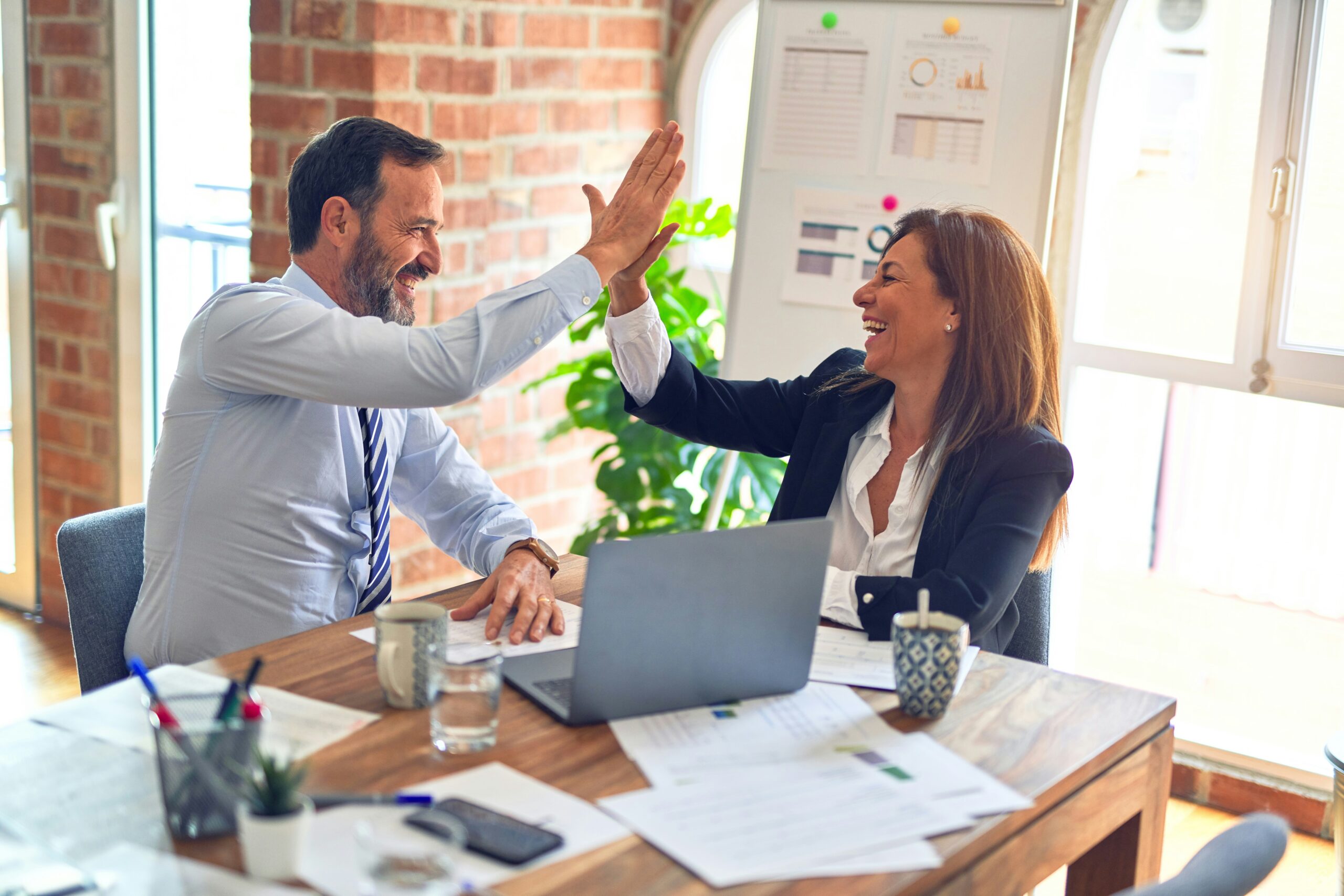 Two colleagues high-fiving.
