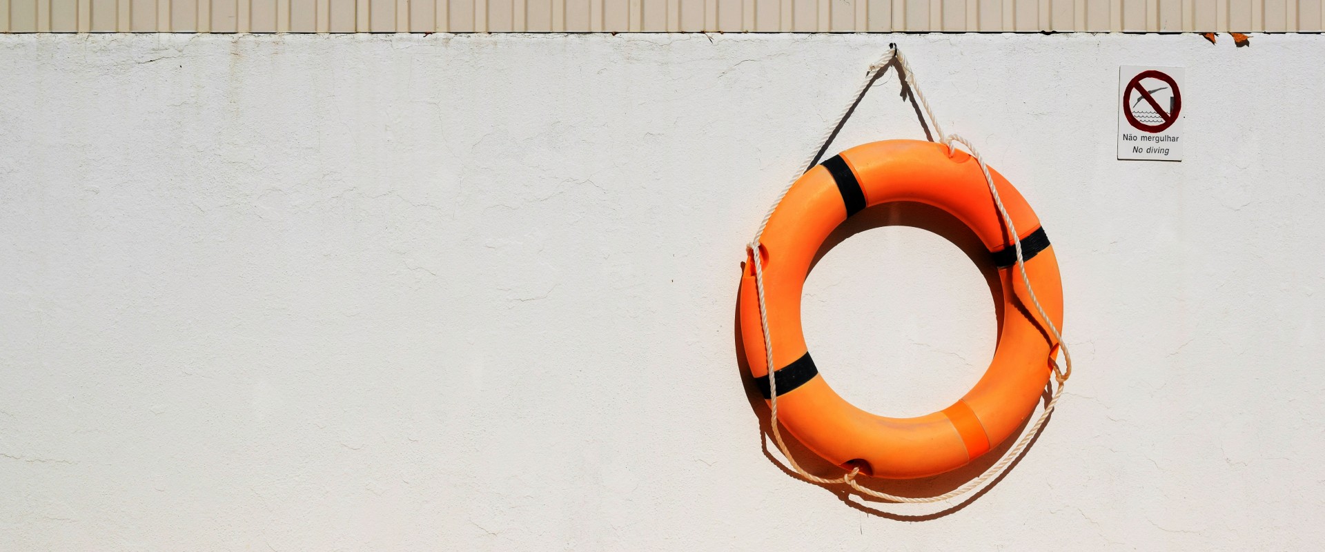 Life preserver hanging on side of ship