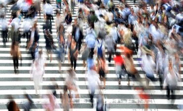 Photo of pedestrians walking in a crowd