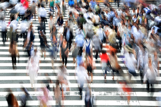 Photo of pedestrians walking in a crowd