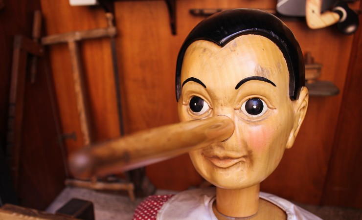 Wooden pinocchio puppet with long nose