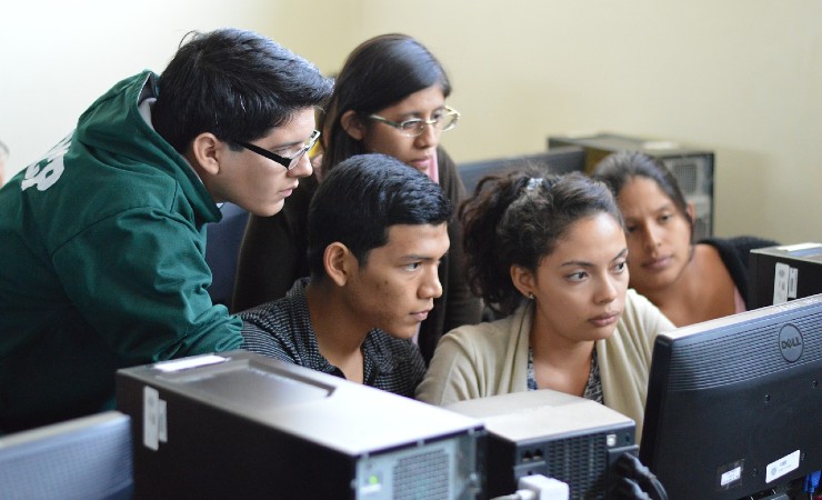 Five university students focused on computer screen